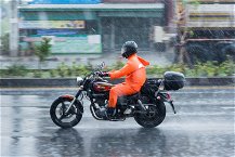 motociclica che indossa poncho per la pioggia
