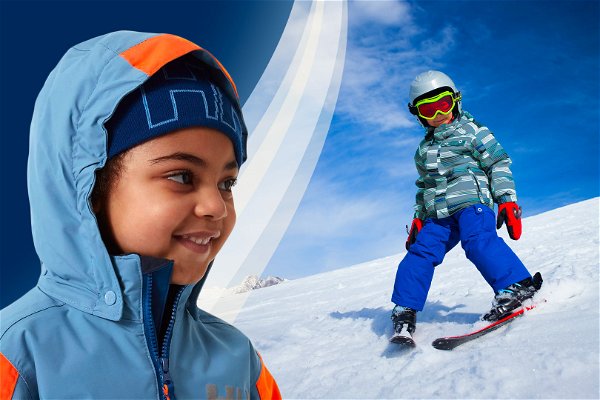 bambina con abbigliamento da sci e bambino che scia