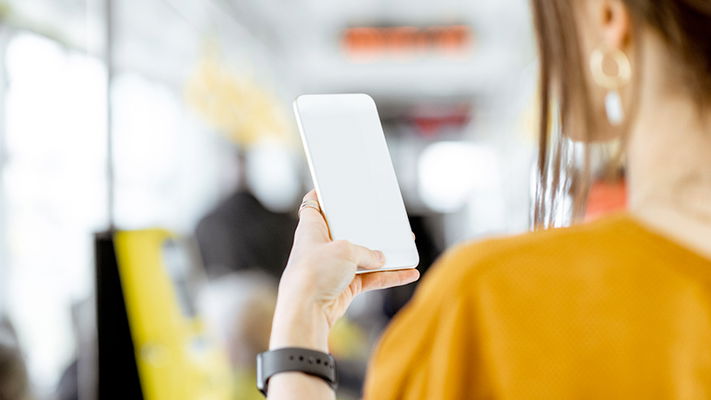 ragazza di spalle che guarda il telefono